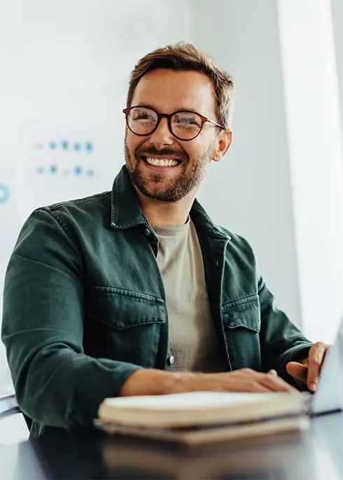 Happy business man listening to a discussion in an office