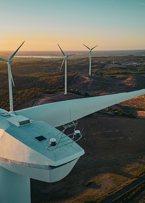 Aerial view of a wind Turbine in a rural scene at sunset time in the south of Portugal